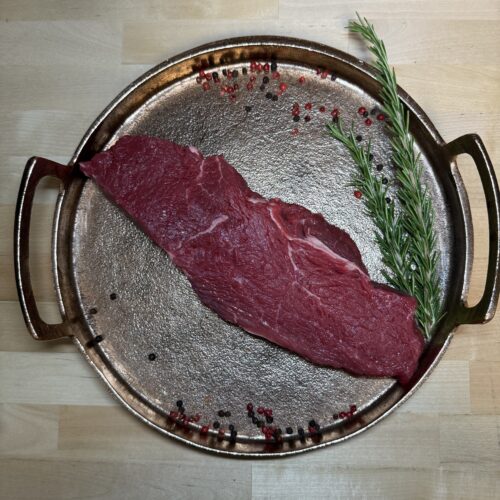 Sirloin steak on a tray of garnishment