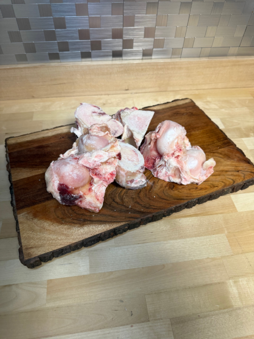 A board full of various sizes of beef knuckle bones