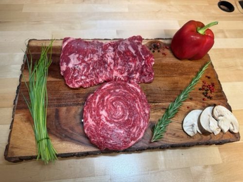Unrolled skirt steak and a rolled pinwheel like cross section of skirt steak