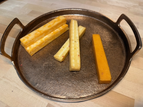 A tray of assorted smoked cheeses