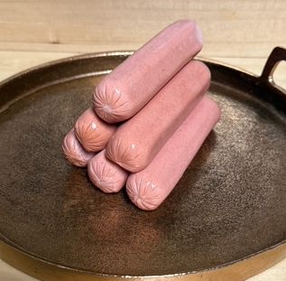 A stack of angus hot dogs