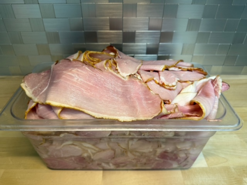 A bin of carved off the bone deli ham