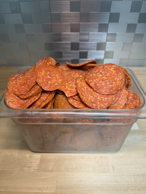 A bin full of sandwich pepperoni