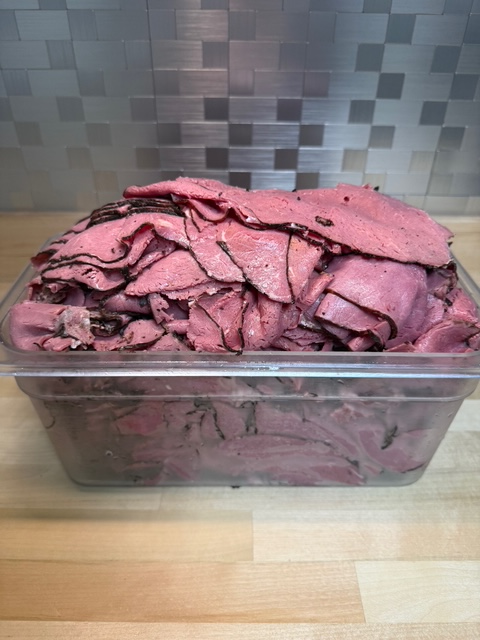 A bin of sliced pastrami