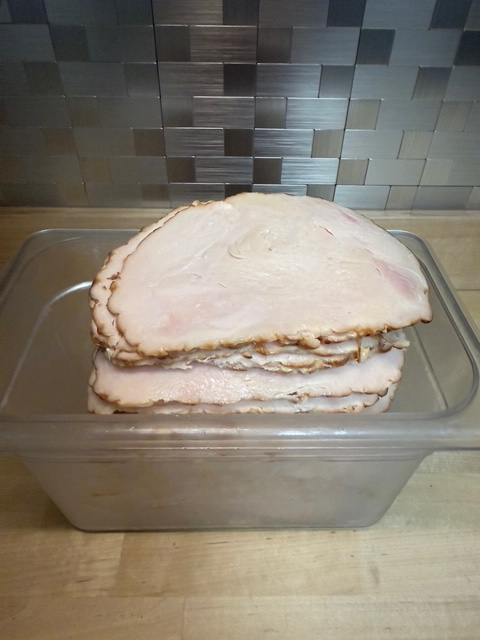 A bin of roasted chicken deli meat