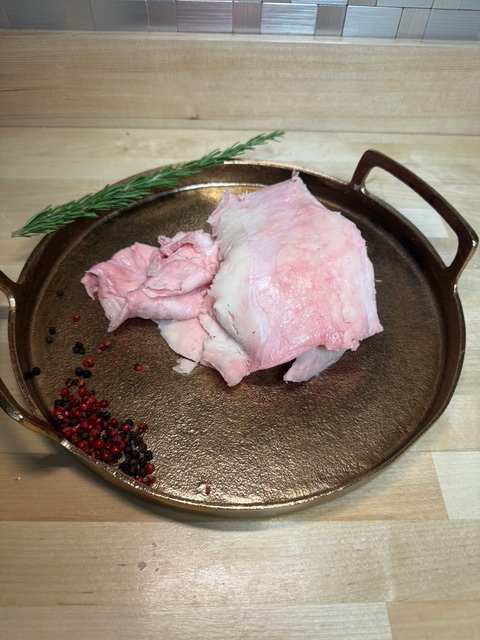 A pile of beef fat on a tray of garnishments