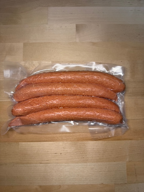 A four pack of frozen vacuum sealed Zenner's branded wieners.