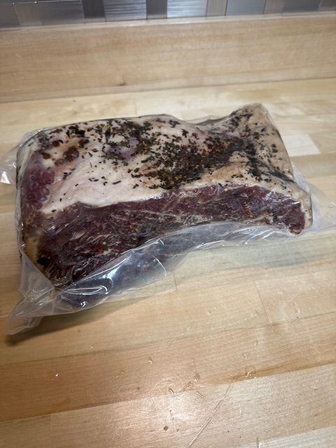 A vacuum sealed pack of Corned beef round.