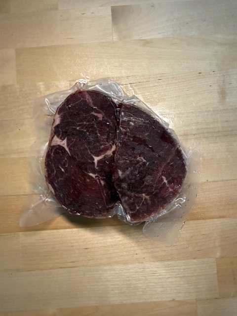 A frozen pack of vacuum sealed two Venison Loin Chops