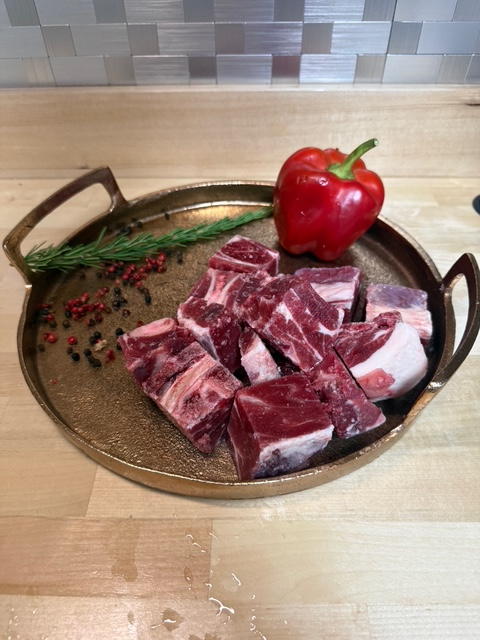 Cubed Lamb meat for stew on a tray of garnishment