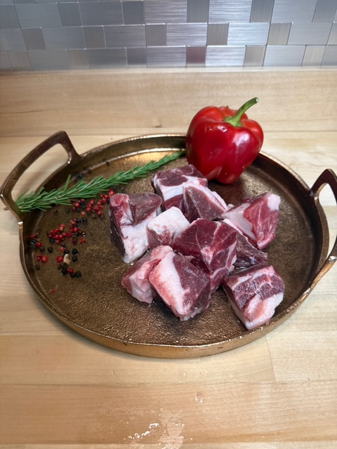 Cubed bone in goat on a tray with garnishments
