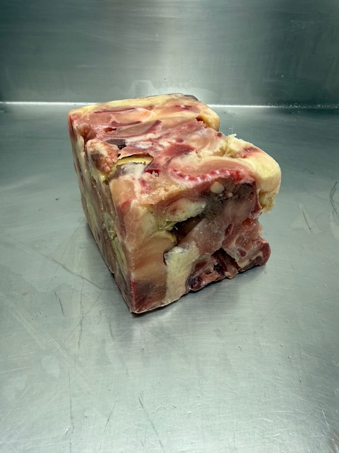 A cube of frozen chicken necks