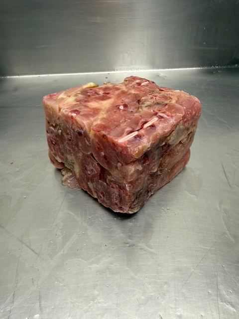 A block of frozen chicken backs