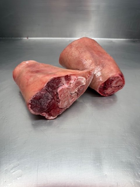 Two Frozen Bone In Pork Shanks. They are skin on.