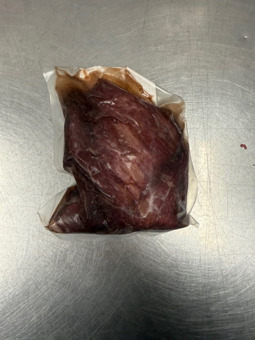A frozen vacuum sealed bison tenderloin filet.