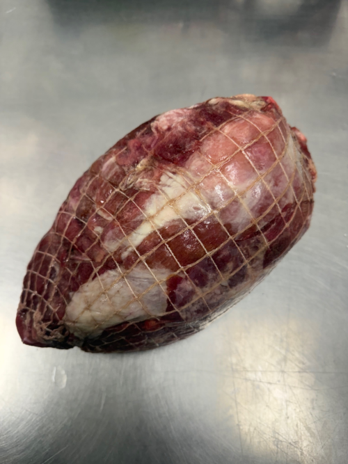 A netted boneless wild boar shoulder.