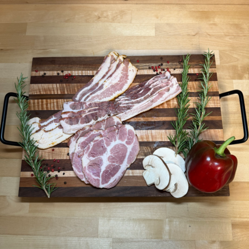 Three different bacons on a board of garnishments