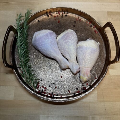 Three chicken drums on a tray of garnishments