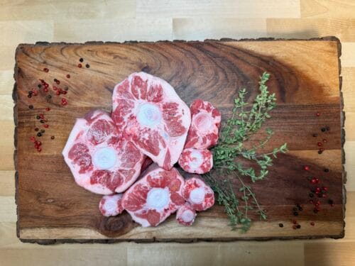 Sections of oxtail on a board of garnishments