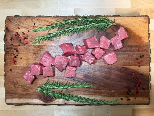 Cubed Stew meat on a board of garnishments