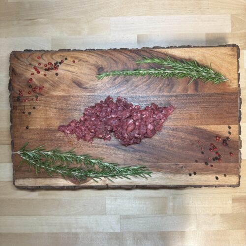 A half pound of chili grind on a board of garnishments