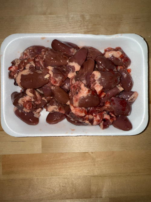A tray full of fresh chicken hearts